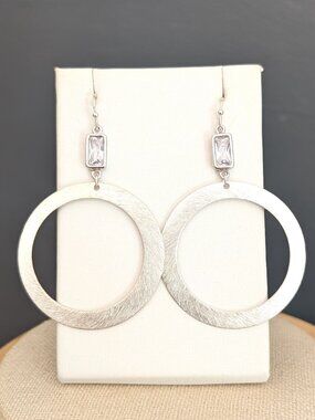 Brushed silver tone drop hoop earrings with clear bead accents